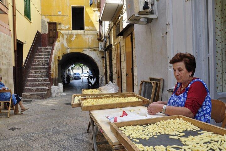 An older woman making food on the streets