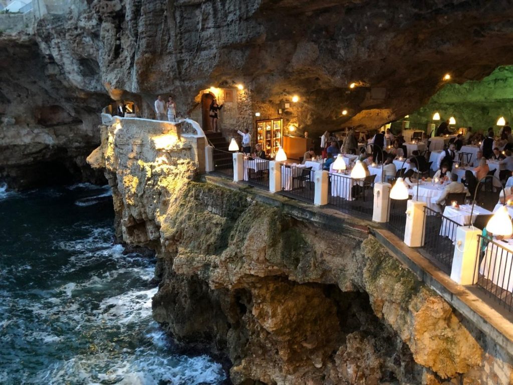 People dining seaside in a grotto