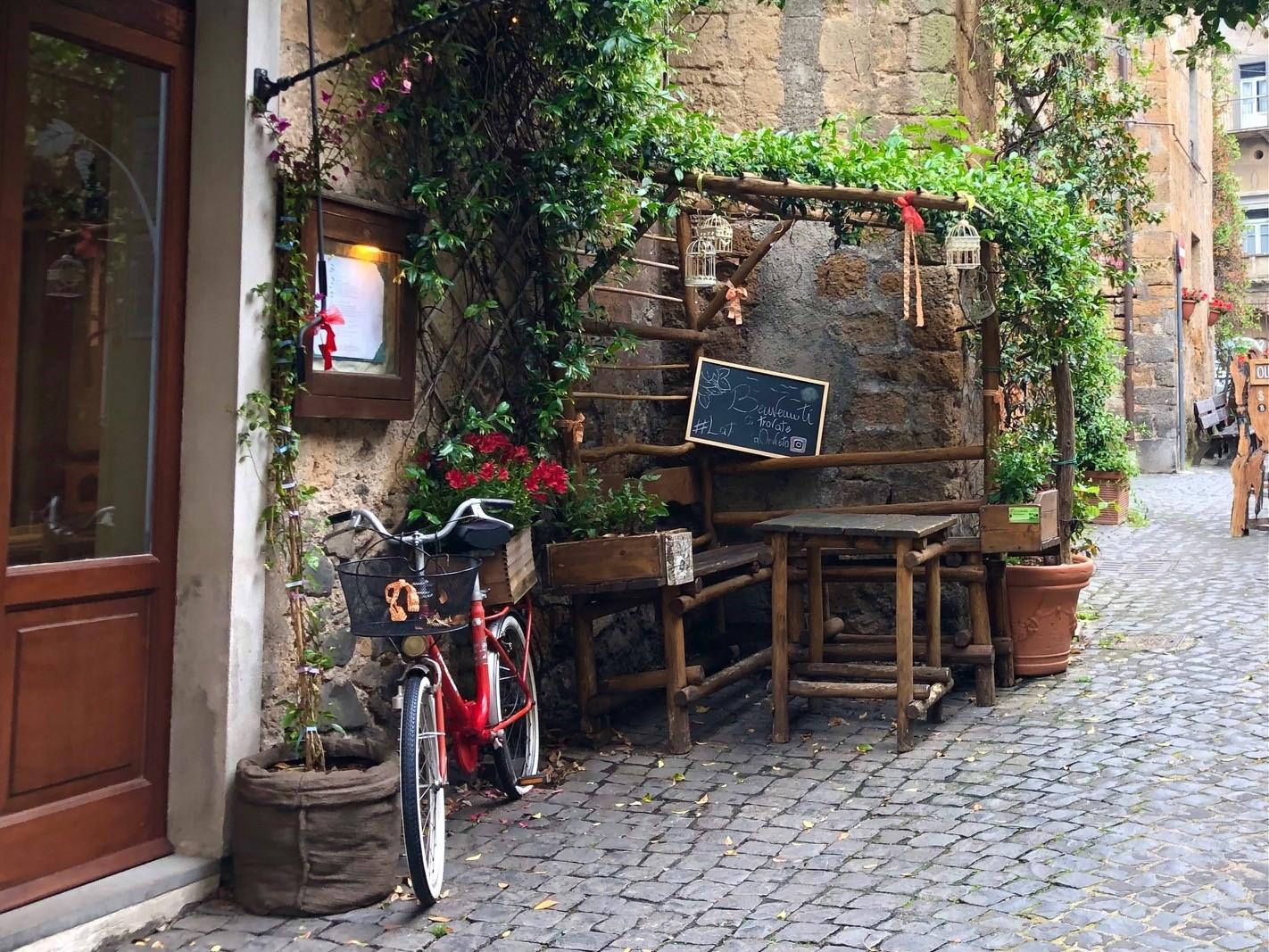 A bicycle leaned next to a doorway in a sidestreet of Orvieto.