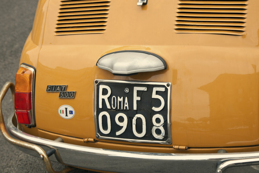 "Rome, Italy - January 22, 2012: Fiat 500 seen on the street in the center of Rome. Fiat 500 was produced by the Fiat company between 1957 and 75. New version of this car started production in 2007."