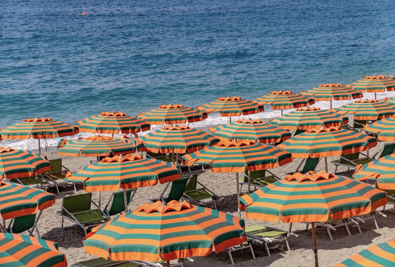 orange and green umbrellas on a beach