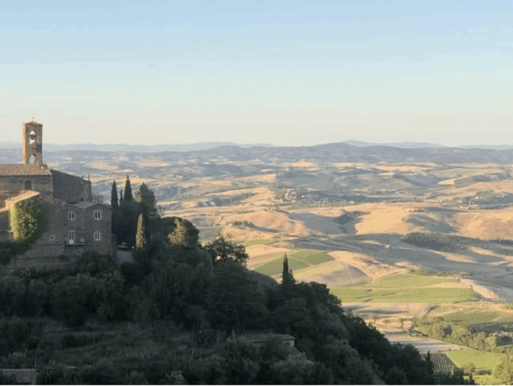 The sun casting shadows on the fields looking at Tuscany's best towns 