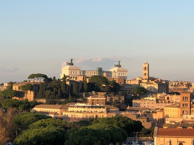 Panoramic view of Rome’s historic skyline at golden hour, featuring classical architecture and landmarks